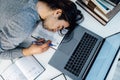 High angle view of tired businessman sleeping while calculating expenses at desk in office. Royalty Free Stock Photo