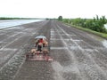 High angle view, tractor working in paddy field, agricultural scene