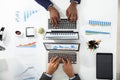 Two Businesspeople Analyzing Graph On Laptop Royalty Free Stock Photo