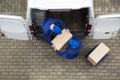 Two Delivery Men Unloading Cardboard Box From Truck Royalty Free Stock Photo