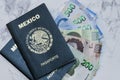 High angle view of two Mexican Passports and pesos on the table under the lights