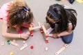 High-angle view of two pre-school girls sharing wooden toy blocks Royalty Free Stock Photo