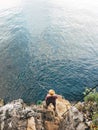 High angle view of unrecognizable male with straw hat fishing with rod