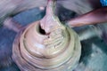 High angle view , unrecognizable potter making clay pot by moulding on traditional cart wheel - concept of handcraft