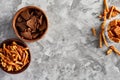 Variety of beer snacks on grey background. Copy space