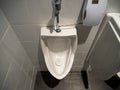 High angle view of a white porcelain urinal in a male public toilet