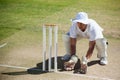 High angle view of wicketkeeper crouching behind stumps Royalty Free Stock Photo