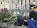 High angle view of woman crouching while holding a plant. Gardening concept Royalty Free Stock Photo