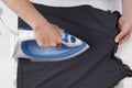 High angle view of woman ironing on ironing board Royalty Free Stock Photo