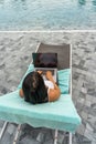 High angle view of woman typing laptop on summer vacation Royalty Free Stock Photo