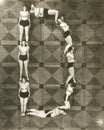 High angle view of women forming the letter D