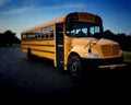 High angle view of yellow American public school bus front right door side commonly used to transport kids to school, field trips Royalty Free Stock Photo