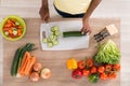 Young African Woman Chopping Vegetables In Kitchen Royalty Free Stock Photo