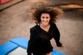 High angle view of young cheerful woman jumping on trampoline. Royalty Free Stock Photo