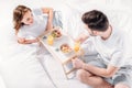 high angle view of young couple having breakfast in bed Royalty Free Stock Photo