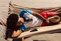 Man sleeping in a hammock on the beach Royalty Free Stock Photo