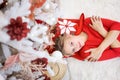 High angle view young woman lying on floor near Christmas tree with gifts. Top Royalty Free Stock Photo