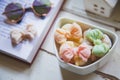 High angle views Allure Thai candy in a mini bowl on a rustic wooden table with an open book, Allure is traditional Thai desserts