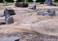 High angle wide shot of rock structures lying on concrete ground with unique circular patterns. Zen concept