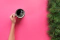 High angle of woman hands holding coffee mug on pink background Minimalistic style. Flat lay, top view isolated Royalty Free Stock Photo