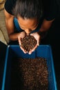 High angle of woman holding and smelling fried coffee