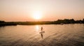 High angle of a woman silhouette on a boat sailing in the river at sunset Royalty Free Stock Photo