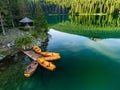 High-angle of wooden boats near Crno Jezero river,water reflecting cloudy sky, and rocks Royalty Free Stock Photo