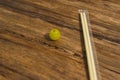 High angle of a yellow grape and a pair of chopsticks placed on a wooden table. Royalty Free Stock Photo