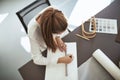 Young female architect drafting drawings at her office desk