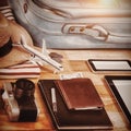 High anlge view of diary with currency by digital tablet and luggage
