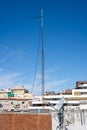 High antenna mast on the rooftop of a building