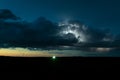 A high based thunderstorm over the plains of North Dakota is illuminated by lightning during the twilight hour Royalty Free Stock Photo