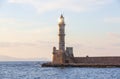 High, beautiful, ancient lighthouse made of bricks. Marvelous sunset lights the sky. Local place Chania, Creete island, Greece. Royalty Free Stock Photo