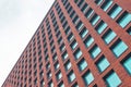 High brick wall with square windows and glass