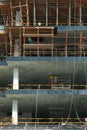 Multi-story building construction site with workers on scaffolds