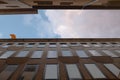 High building facade forced ground perspective on a narrow street