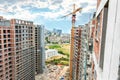 High buildings scaffold with crane at the construction site, city view Royalty Free Stock Photo