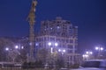 High buildings under construction with cranes at evening . Lightening multi-storey buildings under construction and cranes at nigh Royalty Free Stock Photo