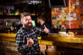 High calorie snack. Hipster relaxing at pub. Pub is relaxing place to have drink and relax. Brutal hipster bearded man Royalty Free Stock Photo