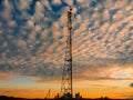 High cell tower and evening sky with beautiful clouds Royalty Free Stock Photo