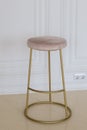 high chair with golden metal legs in the interior Royalty Free Stock Photo