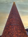 High chimney of the Sihl paper factory covered with fairy lights at sunset.