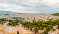 High cityscape view from Acropolis hill with ruined amphitheater and national museum on foreground