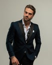 high class sexy man in tuxedo looking to side and holding hand in pocket Royalty Free Stock Photo