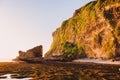 High cliff with rocks, stones, low tide ocean and sunset colors in Bali Royalty Free Stock Photo