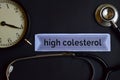 High Colesterol on the print paper with Healthcare Concept Inspiration. alarm clock, Black stethoscope. Royalty Free Stock Photo