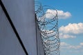 High concrete fence, barbed wire fence on top, pre-trial detention cell, building for execution of punishments for criminals, Royalty Free Stock Photo