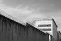 high concrete fence, barbed wire fence on top, pre-trial detention cell, building for execution of punishments for criminals, Royalty Free Stock Photo