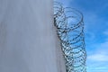 high concrete fence, barbed wire fence on top, pre-trial detention cell, building for execution of punishments for criminals, Royalty Free Stock Photo