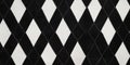 A high-contrast harlequin fabric texture background in black and white diamond patterns. The crisp, Royalty Free Stock Photo